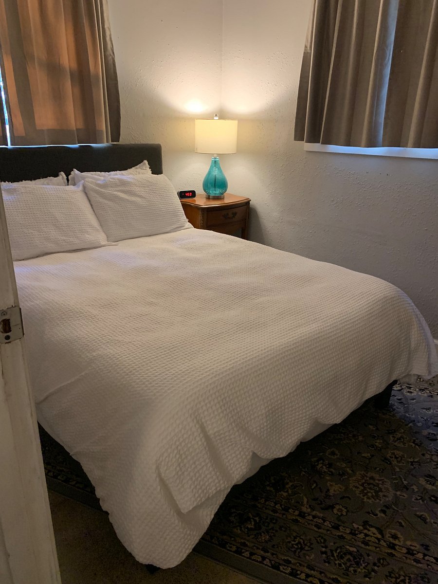 Smaller sized room with closet and built in drawers.