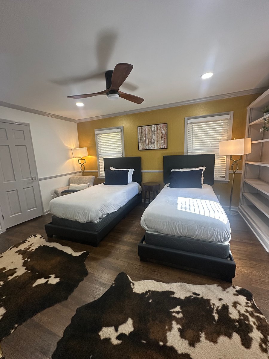 Spacious downstairs bedroom featuring twin beds, ideal for flexibility and comfort.