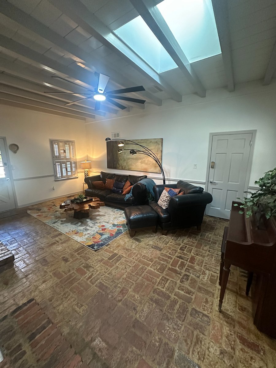Brick walls, brick floors, big screen  a space built for comfort and character.