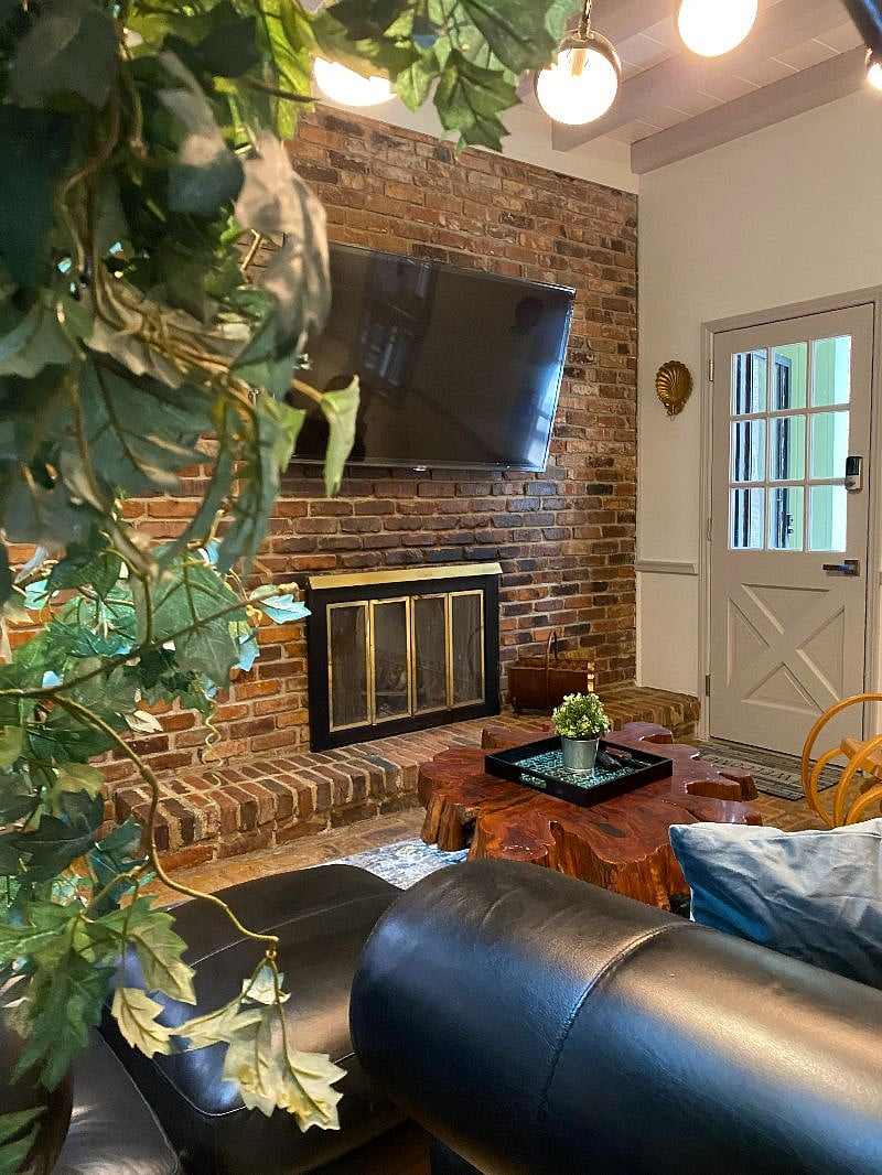 Modern comfort meets rustic charm with this faux-fireplace feature wall.