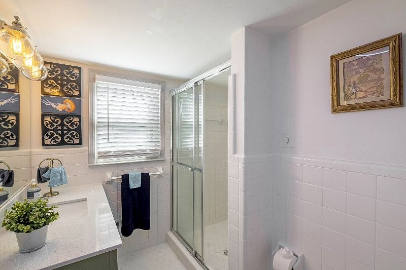 Downstairs shared bathroom  clean, modern, and easily accessible.