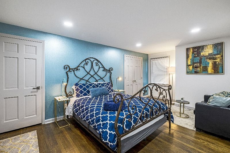 Upstairs bedroom featuring a queen-sized iron bed  classic style and cozy comfort.
