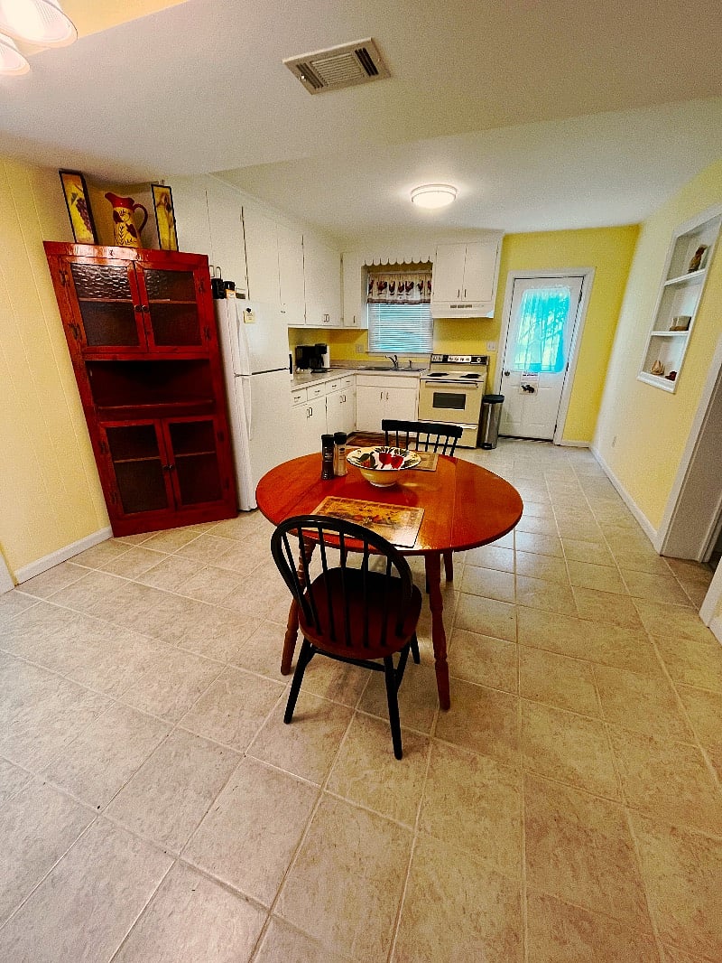 Full kitchen stocked with plates, glasses, flatware, and cookware, microwave, toaster, Refrigerator/freezer with ice maker