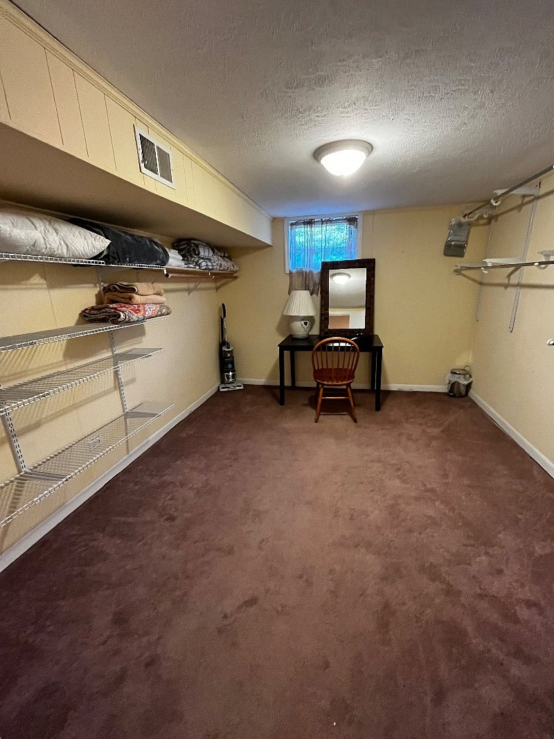 Large walk in closet / dressing room with plenty of storage shelves and hanging space for your belongings