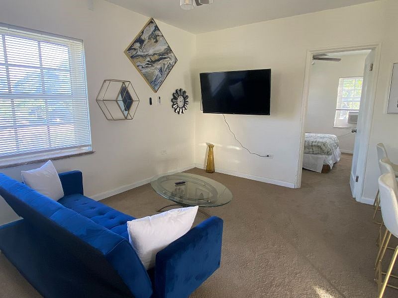 A few steps to your right is the living room area. Watch all your favorite programs on this Smart Roku TV that allows you to log into all your favorite apps!
