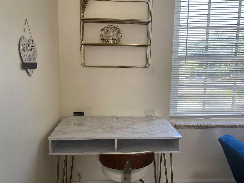 First we have a desk space in the corner with shelving. Work from home in a dedicated area with full courtyard views and refreshing natural light.