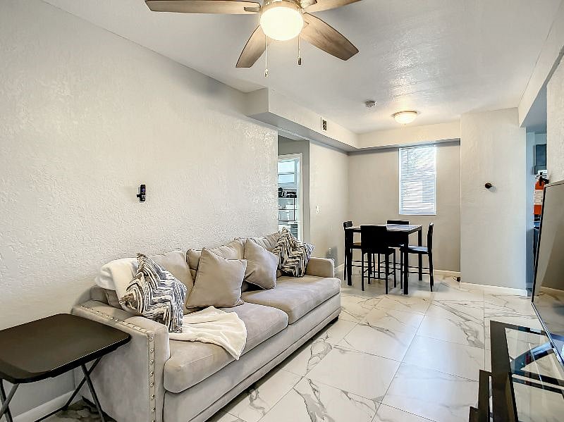 The living room also provides a full central view of the dining area, so you can comfortably eat at a table, or use the TV table provided near the couch.