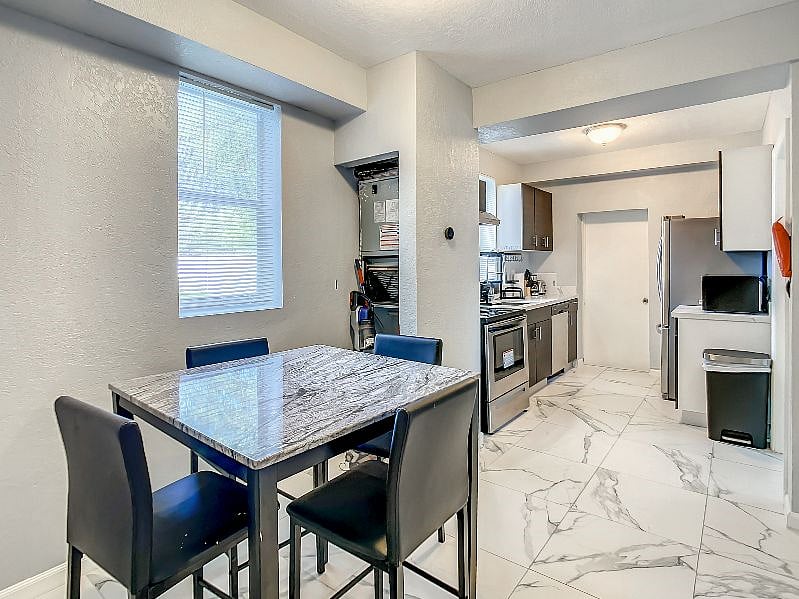 As you walk past the dining area, you'll come into full view of the kitchen which is fully stocked with ALL of your essentials.
