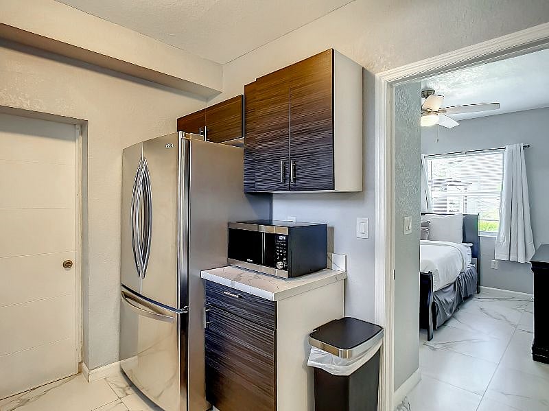 On the other half of the kitchen, we have a huge French Door refrigerator with the freezer at the bottom. You also have a microwave and additional cabinet space.