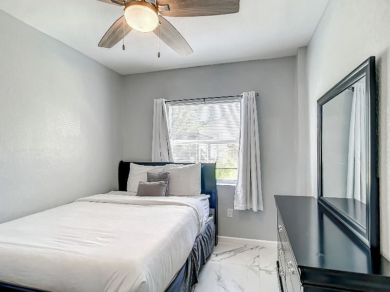 From the kitchen, we can enter directly into Bedroom B, which comes fully furnished with a Queen-size bed, dresser and mirror, and a closet with built-in closet organizer.