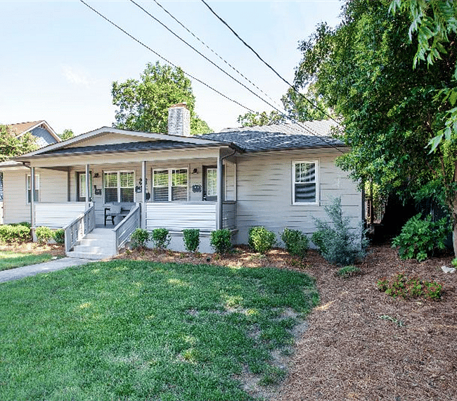 Another view of the front of the house. Two units enter from the porch.  A backdoor off the kitchen leads to a shared patio with gas BBQ and outdoor seating area.