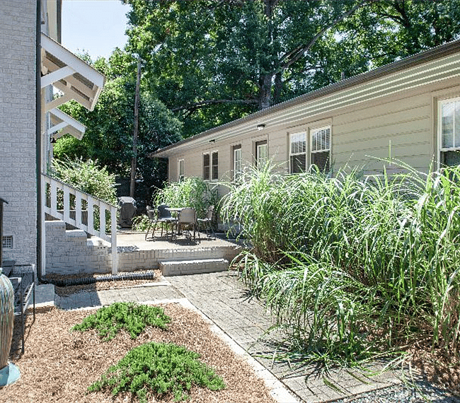 Shared patio with Gas BBQ and seating in between front and rear duplexes
