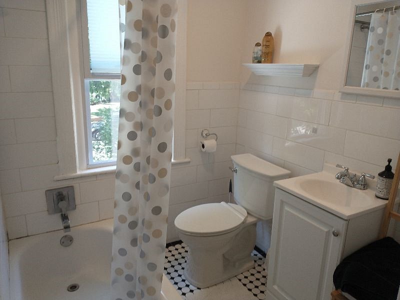 Redone tiled bathroom with full bathtub and shower. Great water pressure.
