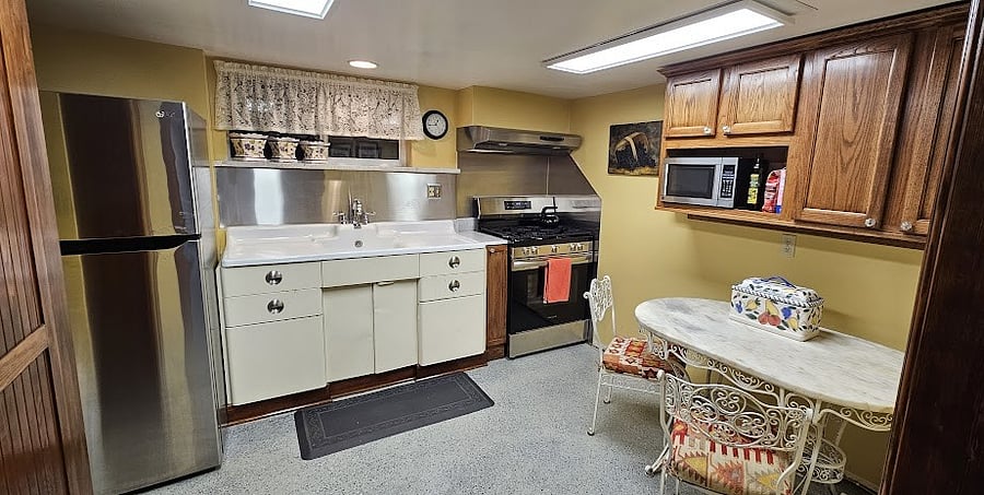 Fully equipped kitchen with large refrigerator, new gas stove, and microwave