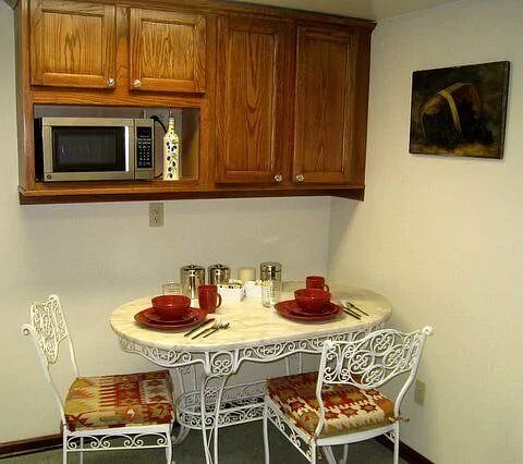 Eating area in the kitchen can seat 4. Dishes, cups, small appliances, pots and pans, and much more provided.