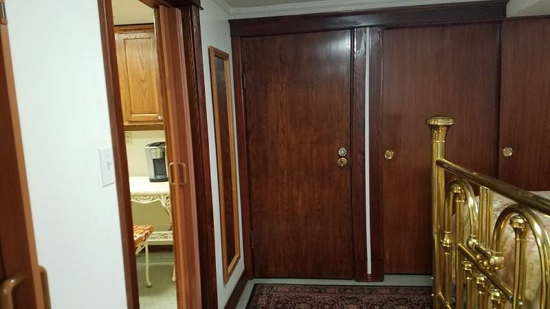 Storage/linen closet in corner between kitchen and bedroom