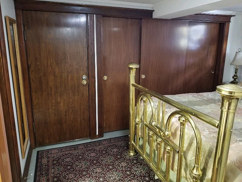 The long closet with 3 sliding doors is 87" wide, with a hanging rod running from one end to the other