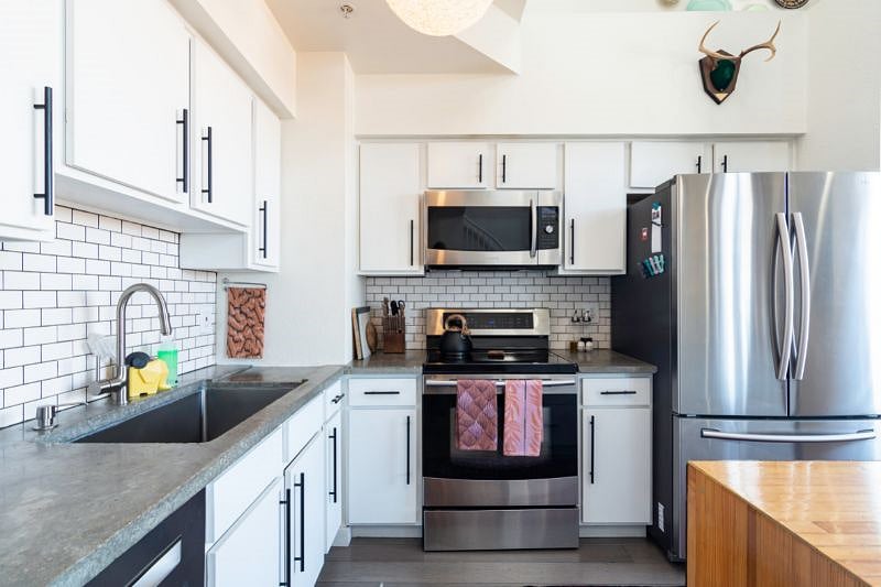 Chef's kitchen with induction stove and oven/microwave combo.
