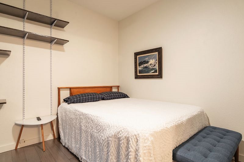 Downstairs guest bedroom with queen bed.