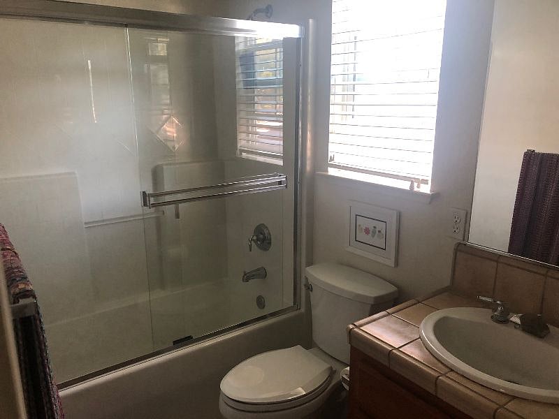 Private bathroom with bathtub and shower