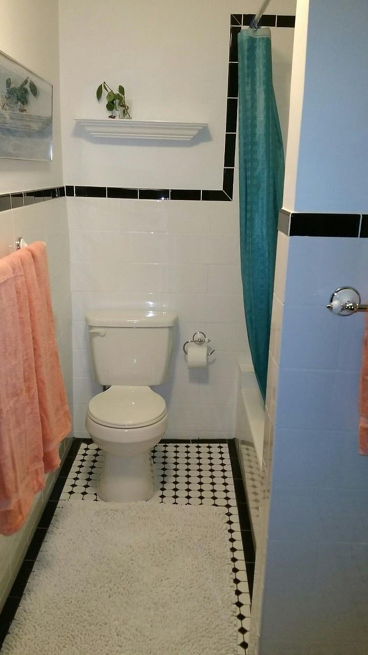 Pretty new bathroom with full bath tub and nice tile.