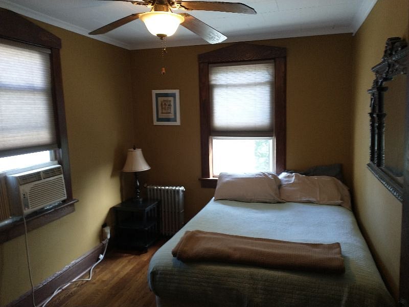 Freshly painted bedroom with Queen bed, ceiling fan and air conditioning.
