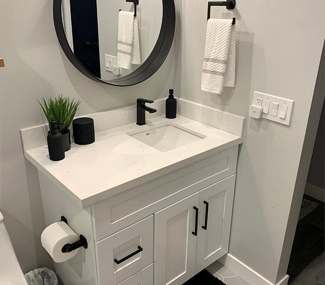 Large vanity with quartz counter tops! Plenty of storage below with hairdryer!
