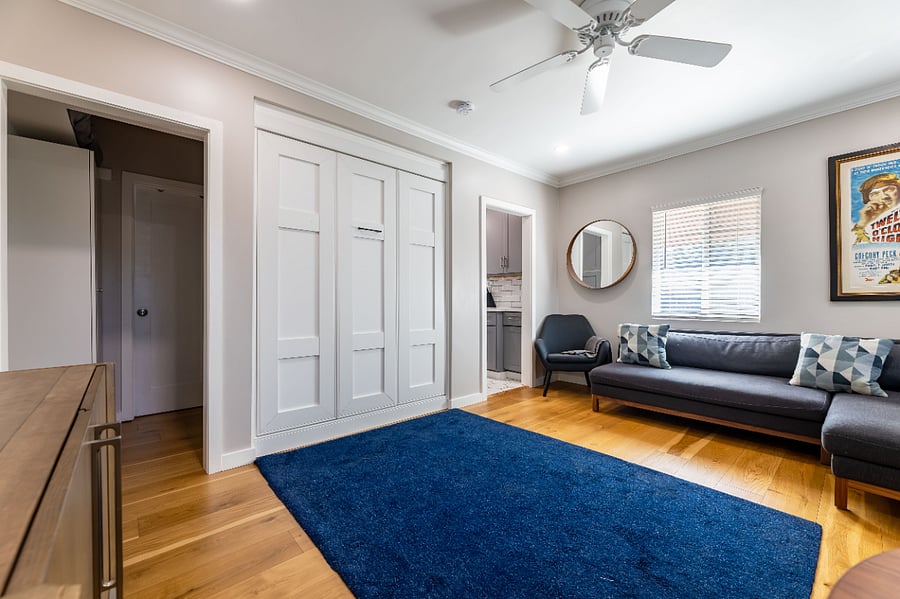 Queen bed folds up hiding into wall to make open living space, folds down to make bedroom.