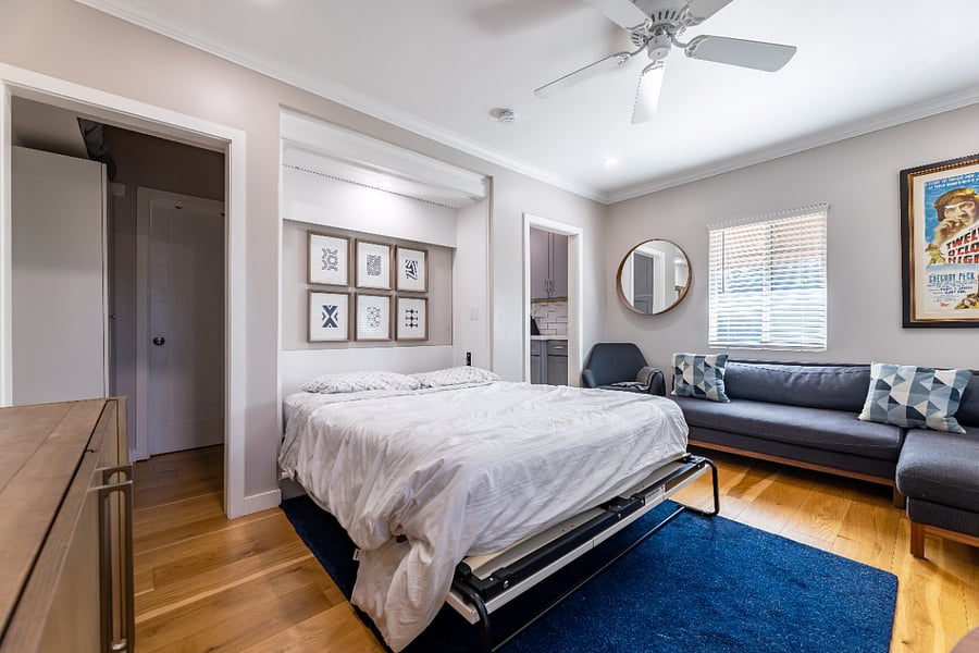 Queen Murphy bed folded down, folds up hiding into wall when not in use.