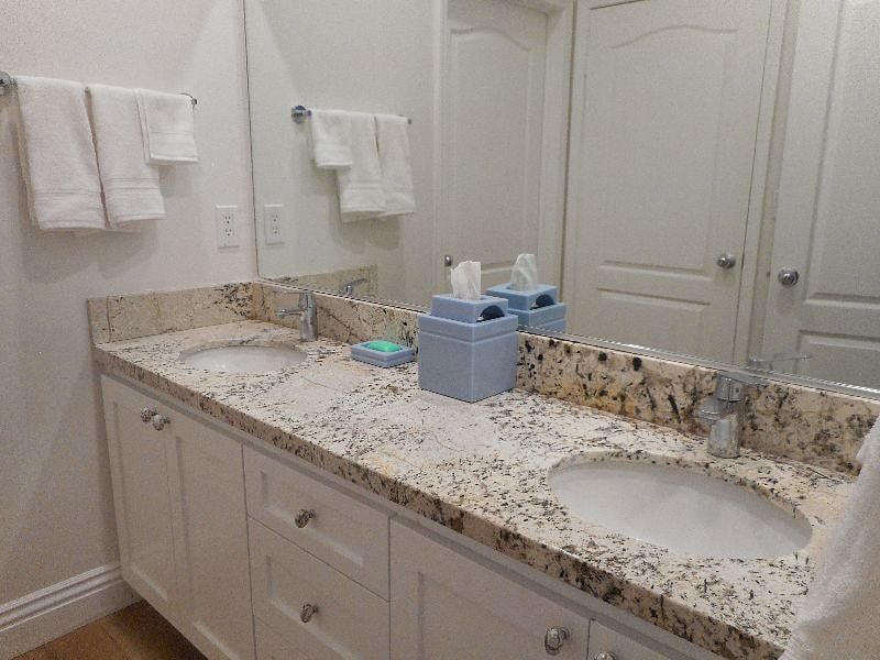 Bathroom counter top with two sinks.