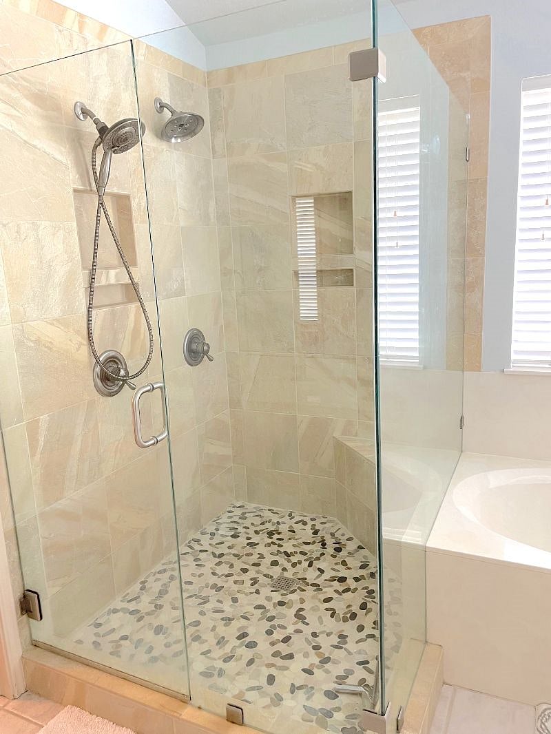 Master walk-in shower with 2 shower heads and tub combo with lots of natural light and a separate toilet room. 