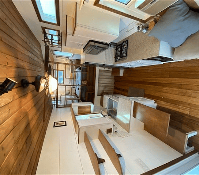 View from guest loft through kitchen toward main bedroom. Kitchen is equipped with quality appliances.