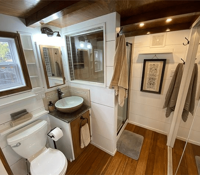 Comfortable and bright bathroom and shower (with shower window). The entire opposite wall of the bathroom is a full size closet with shelves and plenty of space to hang up clothes.