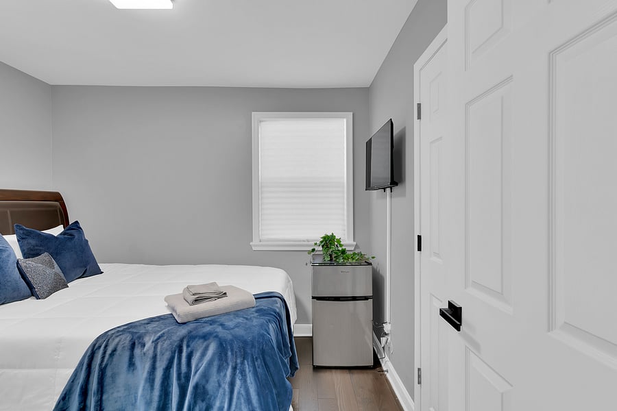 The Guest Suite: A spacious, sun-filled second bedroom with a smart tv, mini fridge, and a relaxing Queen sized bed that comfortably sleeps 2. This room is also adjacent to a full bath just steps away.