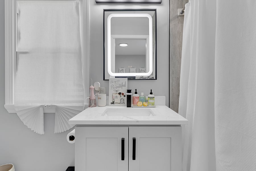The Primary Suite: A peaceful retreat with a private en-suite bath, beautiful antique floor length mirror, and a Queen bed with premium linens which comfortably sleeps 2.