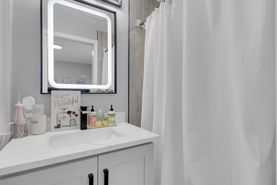 The Primary Suite: A peaceful retreat with a private en-suite bath, beautiful antique floor length mirror, and a Queen bed with premium linens which comfortably sleeps 2.