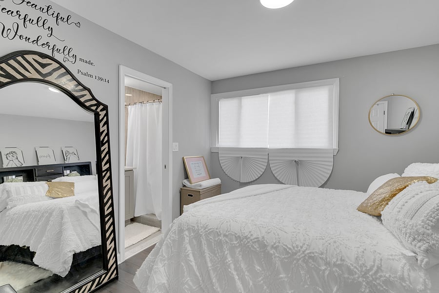 The Primary Suite: A peaceful retreat with a private en-suite bath, beautiful antique floor length mirror, and a Queen bed with premium linens which comfortably sleeps 2.