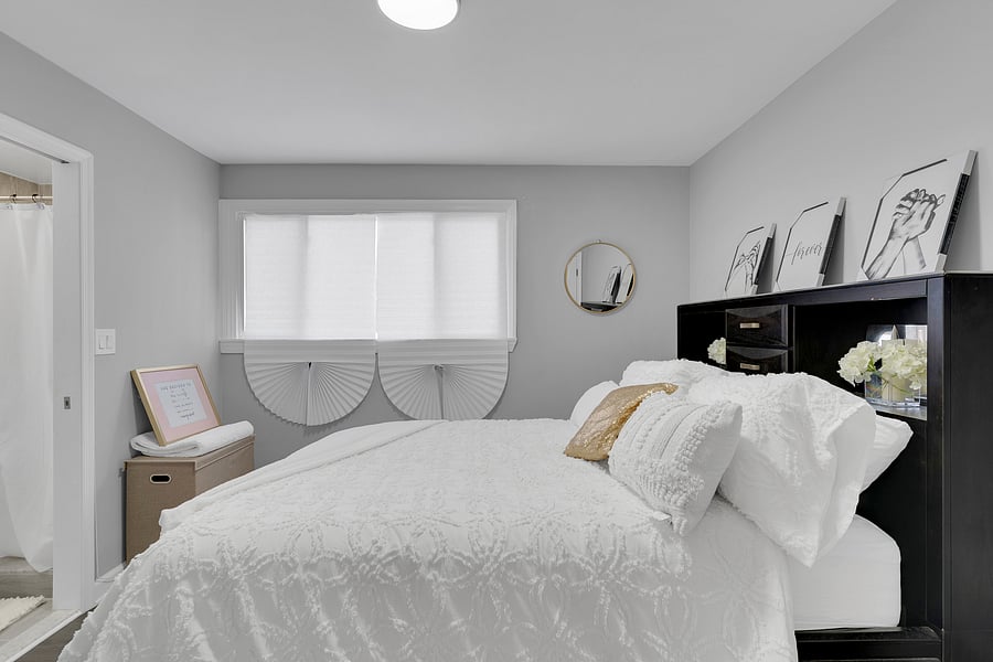 The Primary Suite: A peaceful retreat with a private en-suite bath, beautiful antique floor length mirror, and a Queen bed with premium linens which comfortably sleeps 2.