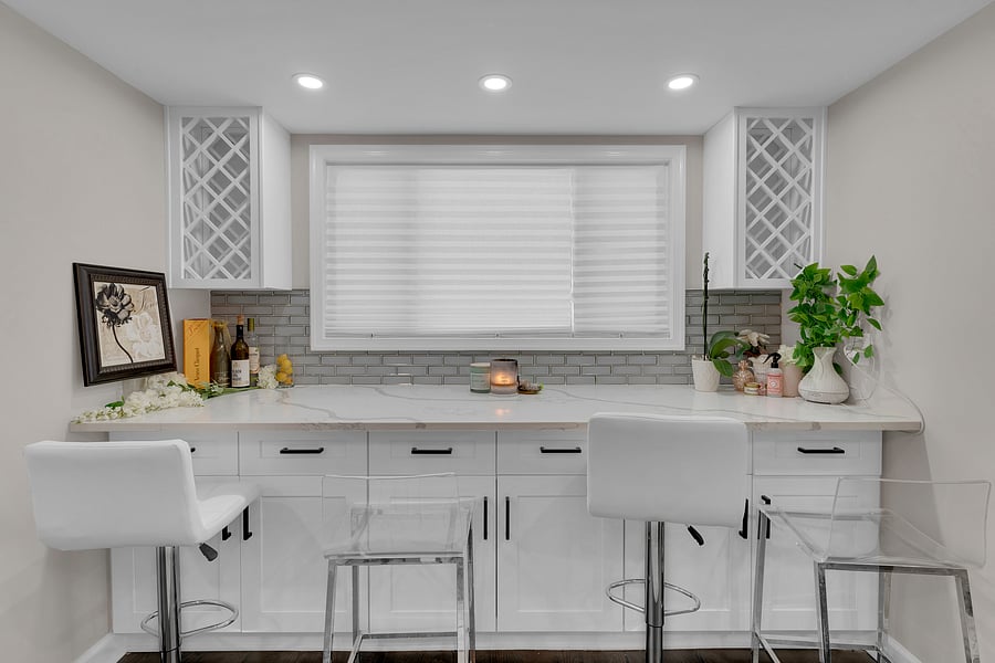Sun-filled alcove houses an expansive island bar that seats four. The perfect spot for a morning espresso, effortlessly converts into a high-functioning workstation for remote projects / study nook complete with high-speed Wi-Fi and nearby charging ports.