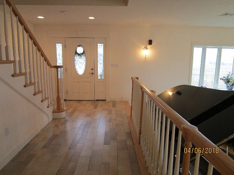 front entry hall, sunken living room to right, stairs to second floor to left  