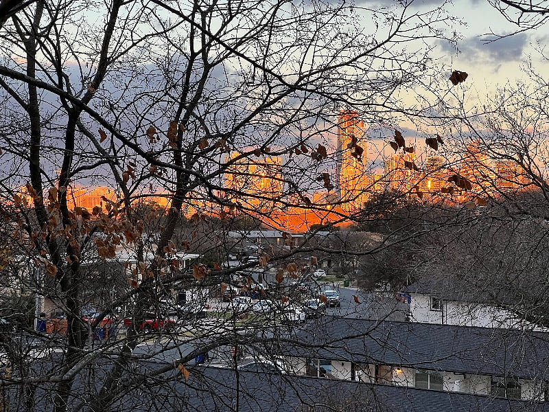 sunsetting on downtown buildings, view from the back side of the house.