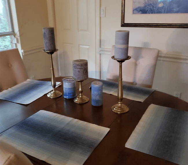 Four-seats dining table with some beautiful candles.