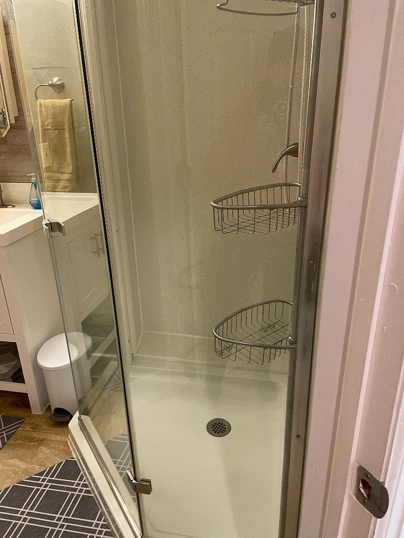 Private bathroom has oversized corner shower.