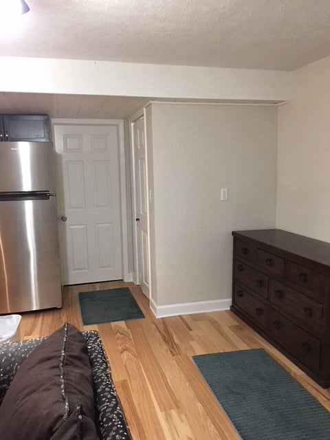 Full size frig and folding door to laundry located under stairway. Stairway to main floor is closed off.