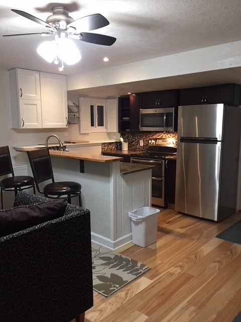 White cabinets with tiled backsplash.