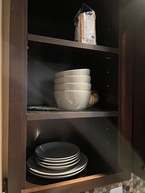 Well equipped kitchen with pots, pans, silverware, utensils, and service for 4.