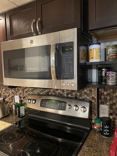 Kitchen appliances are stainless steel.
