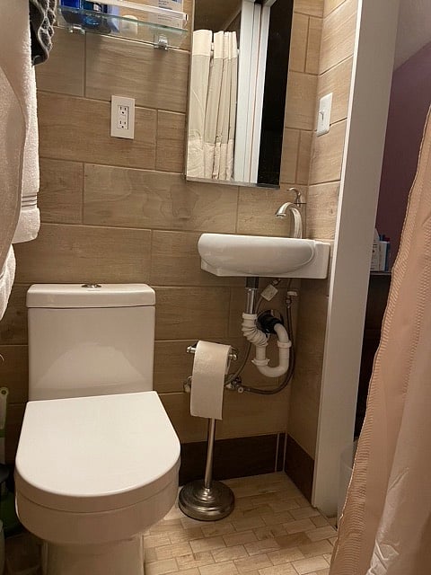 Small but well equipped with large mirrored cabinet and towel warmer.