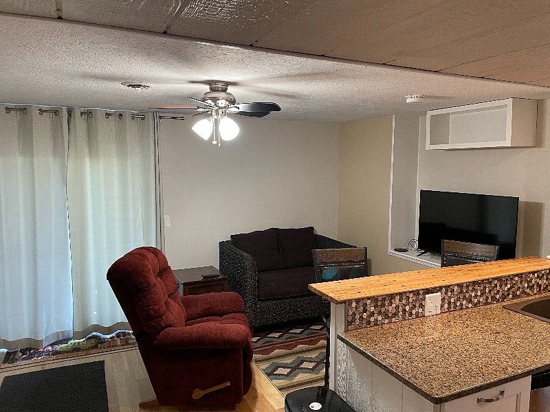 Ceiling fans in both living room and bedroom.