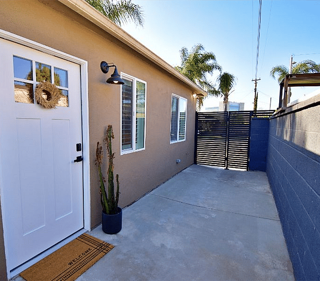 Private, gated entrance with parking space in driveway. 